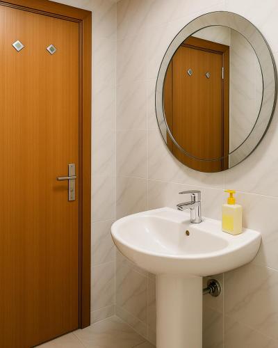 a bathroom with a sink and a mirror at TGB Compact Home JBR Marina Manchester Tower in Dubai