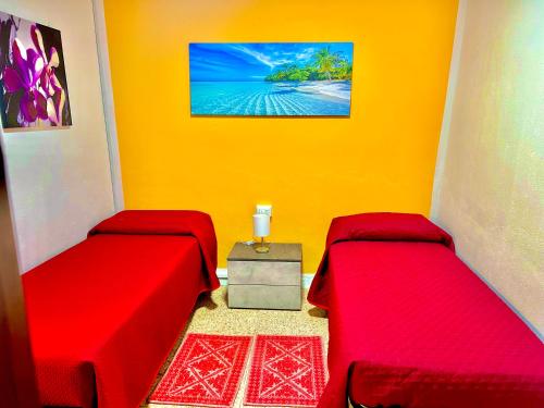 a room with two beds and a picture of the ocean at Civico 31 in Terralba