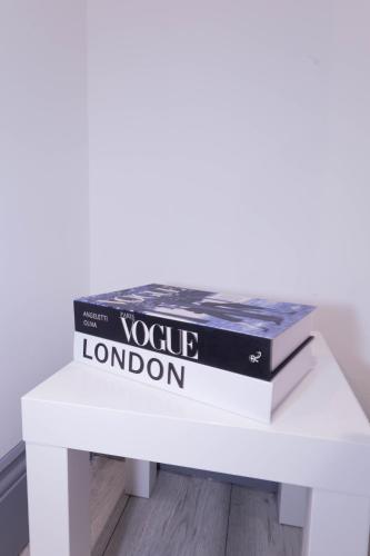 two books sitting on top of a white table at Cosy 3 Bedroom Apartment Near The O2 in London