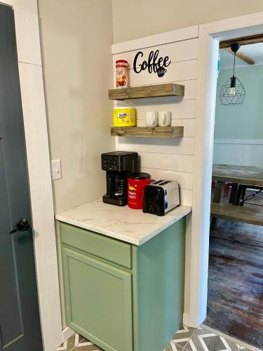 a kitchen with a counter with a coffee station at Charming 4 bedroom farmhouse with large backyard for entertaining in Mountain City