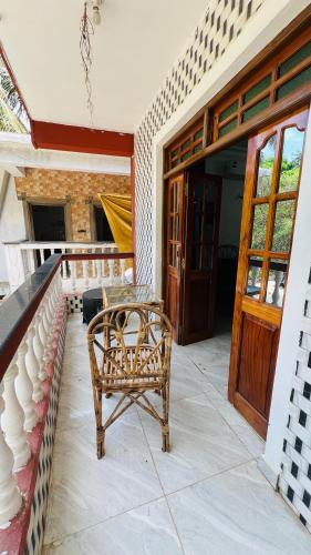 a wicker chair sitting on the porch of a house at De lobos in Calangute
