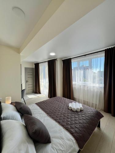 a bedroom with a large bed with two pillows on it at apartments in Ternopil city in Ternopilʼ