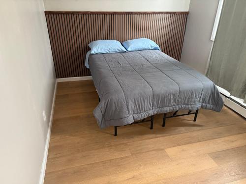 a bed with two pillows on it in a bedroom at 15 mins to NYC-Great Apartment Great for Family in West New York