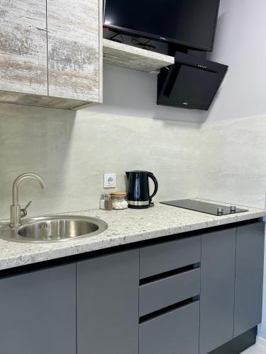 a kitchen counter with a sink and a microwave at apartments in Ternopil city in Ternopilʼ