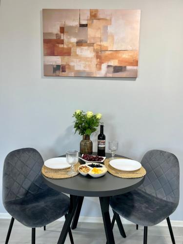 a table with two chairs and a table with food at apartments in Ternopil city in Ternopilʼ