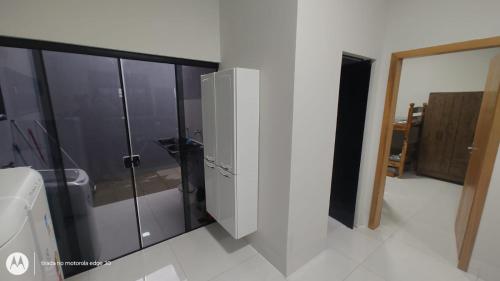 a bathroom with a shower stall and a toilet at Casa Moderna 63 metros com garagem coberta proxima ao centro in Primavera do Leste