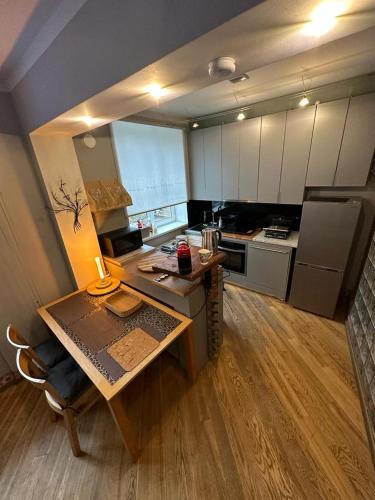 a small kitchen with a table and a stove at Andrea Apartamenti in Jūrmala