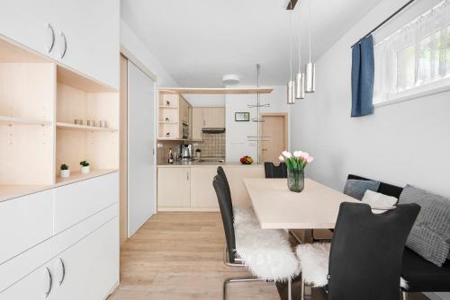 a dining room and kitchen with a table and chairs at Apartment in a quiet part of Brno - Kohoutovice in Jundrov