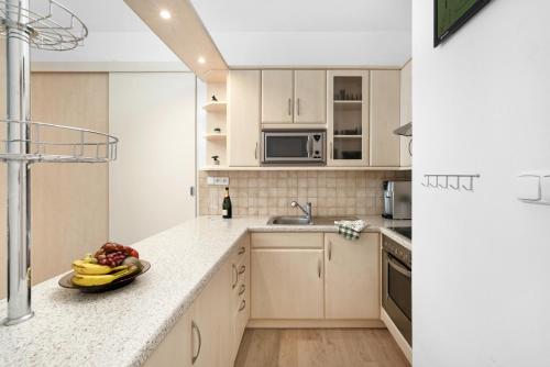 a kitchen with a bowl of fruit on a counter at Apartment in a quiet part of Brno - Kohoutovice in Jundrov