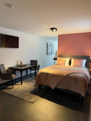a bedroom with a bed and a table and a desk at Sweet Dreams in Middelburg