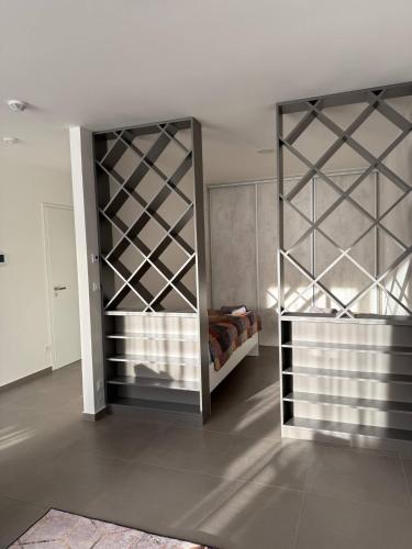 a room with a bed and a wall with a closet at Lion PARKK Apartments in Kníničky