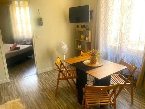 Charme de Blois à 2 min Château Local à vélos في بلوا: غرفة معيشة مع طاولة وكراسي وغرفة نوم