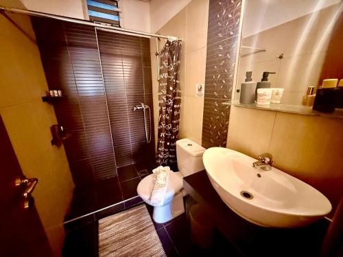 a bathroom with a sink and a shower and a toilet at TRAVELLERS BEAUTIFUL ELEN Agios Gordios Sea in Agios Gordios