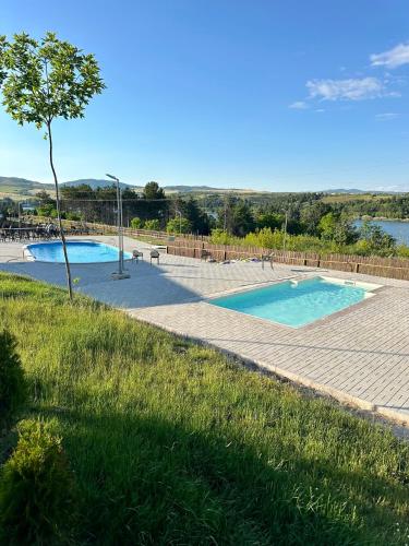 a swimming pool with a tree in the middle at Eco Camp Lake Mladost in Veles