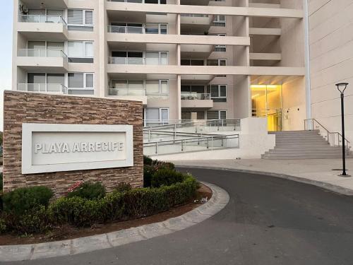 a building with a sign in front of a building at Exclusivo Laguna del Mar in La Serena