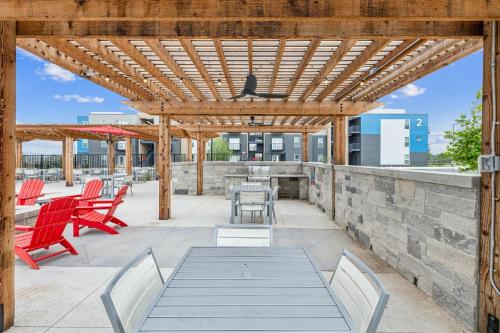 a wooden pergola with chairs and tables on a patio at Luxury Pool Home, Mins To Hospitals, Gym in Marble Falls
