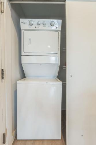 a kitchen with a stove and a refrigerator at Luxury Pool Home, Mins To Hospitals, Gym in Marble Falls