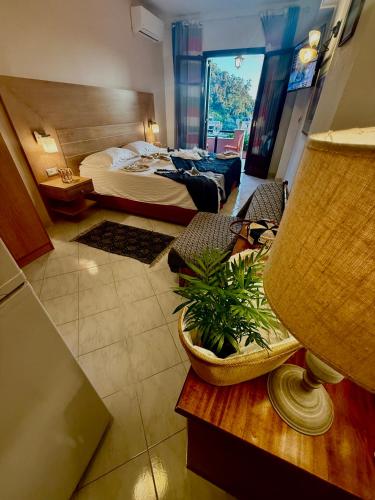 a room with a bed and a table with a lamp at TRAVELLERS BEAUTIFUL ELEN Agios Gordios Sea in Agios Gordios