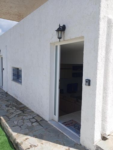 a door to a building with a light on top at Kyriaki's Studio Aigina in Souvala
