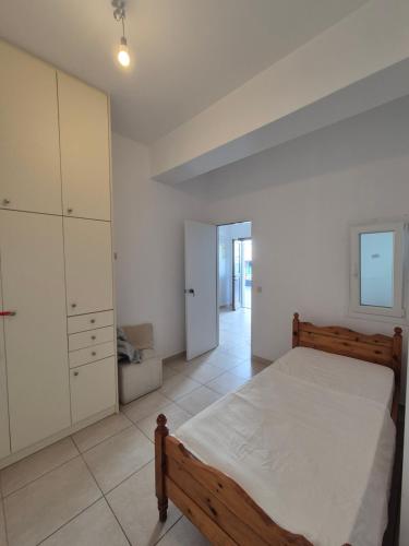 a bedroom with a bed and a cabinet and a room at Iliaxtida apartments in Philotium
