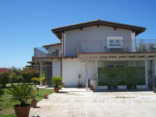 a house with a balcony on top of it at Imperial casa vacanze in Ladispoli