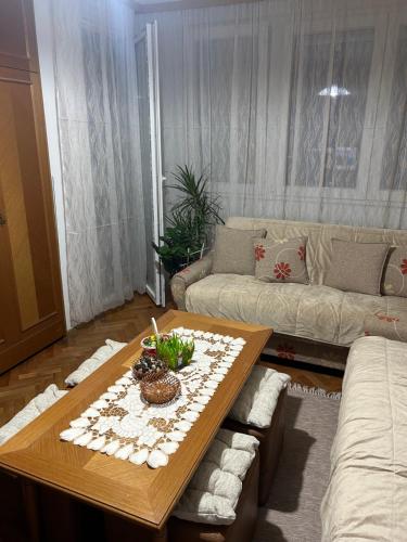 a living room with a table and a couch at Matej3 in Niš
