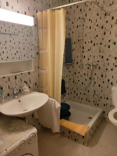 a bathroom with a sink and a shower and a tub at Pfeiren Leukerbad in Leukerbad