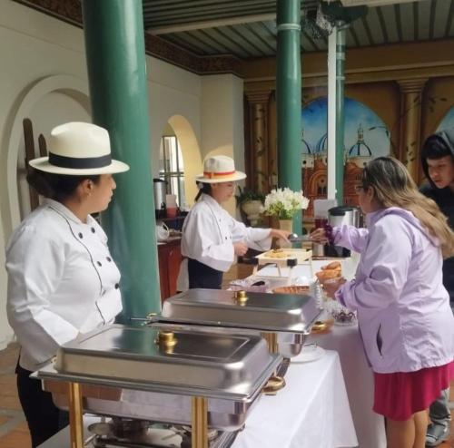 a group of chefs preparing food at a table at Aleros Hotel Boutique in Cuenca