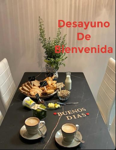 a table with two cups of coffee and a tray of food at Amor-In in Amorín