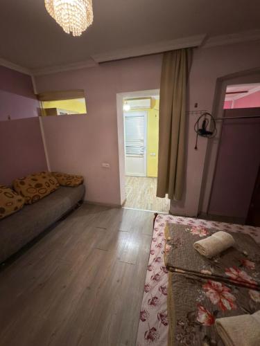 a room with a bed and a hallway with a door at Guest House Nise in Tbilisi City