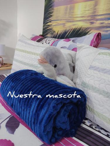 a stuffed animal is sitting on a bed at La casita de Nana in Esparza