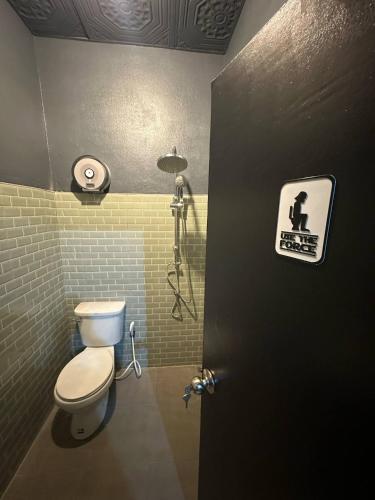 a bathroom with a toilet and a shower at Andaman Genetics 420 Rooms in Ao Nang 