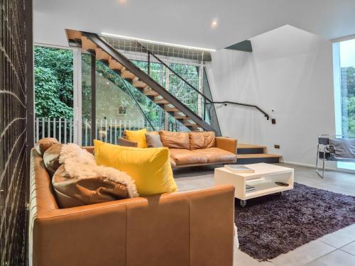 a living room with a couch and a table at Luxury Wellington Accomodation in Wellington