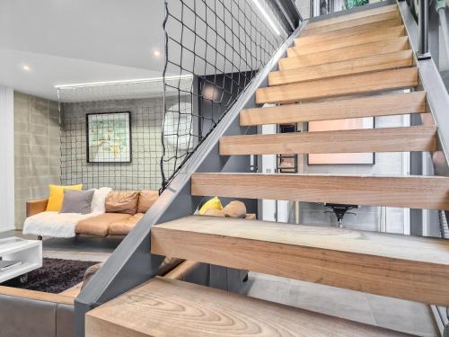 a room with a staircase with a bed in it at Luxury Wellington Accomodation in Wellington