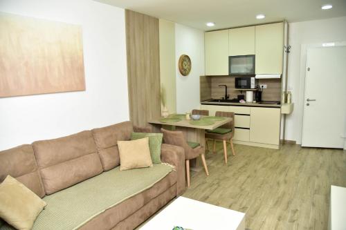 a living room with a couch and a dining room at Silver Dream 1 in Veliko Gradište