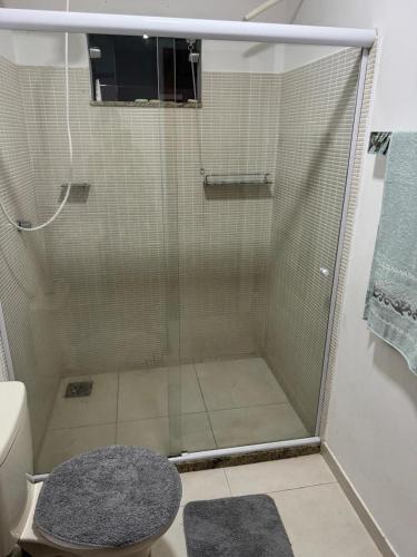 a shower with a glass door in a bathroom at Suite Dunas do Peró in Cabo Frio