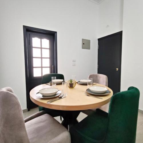 a dining room table with chairs and a wooden table and sidx sidx sidx at Ocean Apartment in Safaga