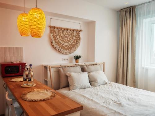 a bedroom with a bed and a table with bottles on it at Garsoniera Rin Grand in Bucharest