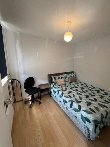 a bedroom with a bed and a desk and a chair at Amazing New Bed Stay in New Cross Goldsmiths in London