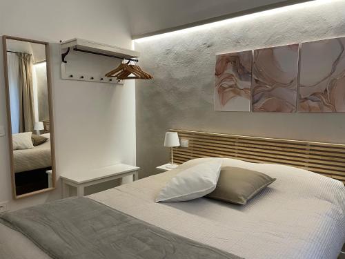 a bedroom with a bed and a mirror at Casa Castello in Volterra