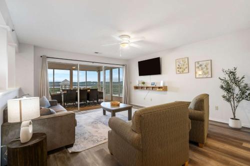 a living room with two chairs and a tv at Ozark Mountain Oasis - For 7 in Kimberling City