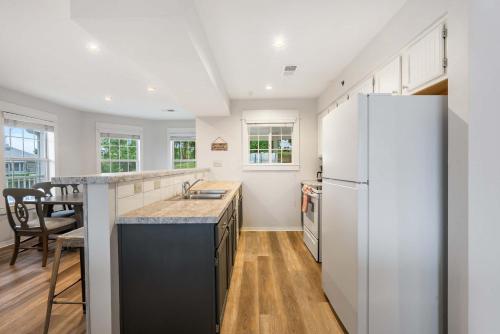 a kitchen with white appliances and a refrigerator at Ozark Mountain Oasis - For 7 in Kimberling City