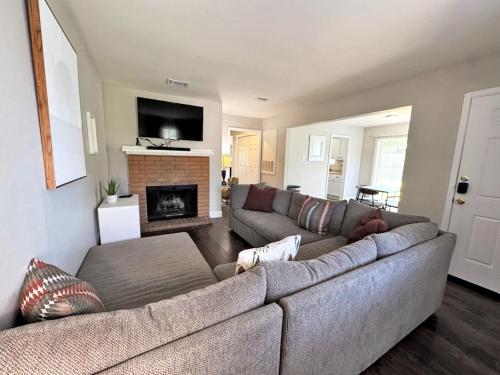 a living room with a couch and a fireplace at Cozy Stay in Bryan, TX in Bryan