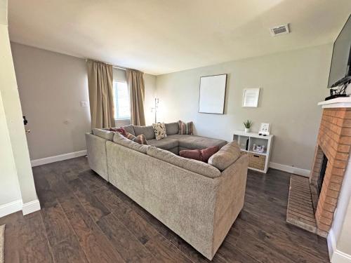 a living room with a couch and a fireplace at Cozy Stay in Bryan, TX in Bryan