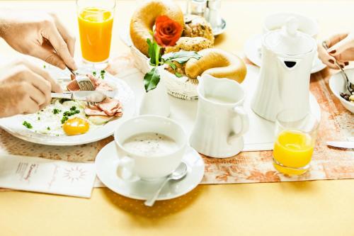 a table topped with plates of food and drinks at Dreilandhof in Loipersdorf bei Fürstenfeld