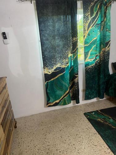 a room with a painting on the wall at Entire 3 bedrooms in Saint Thomas Jamaica fully air-conditioning in Port Morant