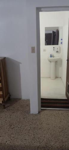 a bathroom with a sink and a mirror at Entire 3 bedrooms in Saint Thomas Jamaica fully air-conditioning in Port Morant