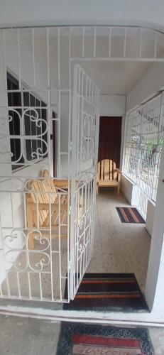 a white spiral staircase in a room with a chair at Entire 3 bedrooms in Saint Thomas Jamaica fully air-conditioning in Port Morant
