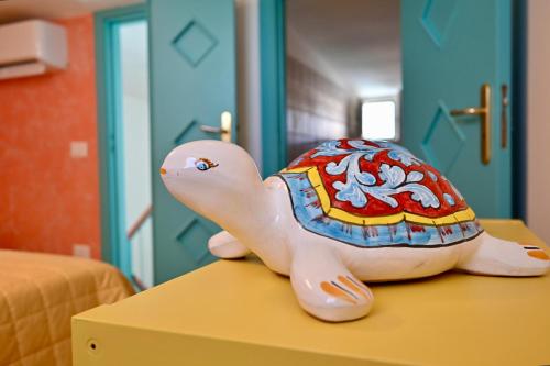 a toy turtle sitting on top of a table at Vieste Rooftop - Sea view near Pizzomunno - Free private Parking in Vieste