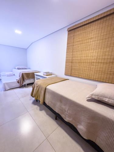 a room with two beds and a window at Halmá Homes in Bonito